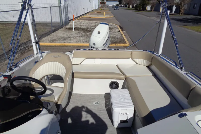 Slide: The Image of 2016 Stingray 192 SC boat interior with beige seating and steering wheel. - 22