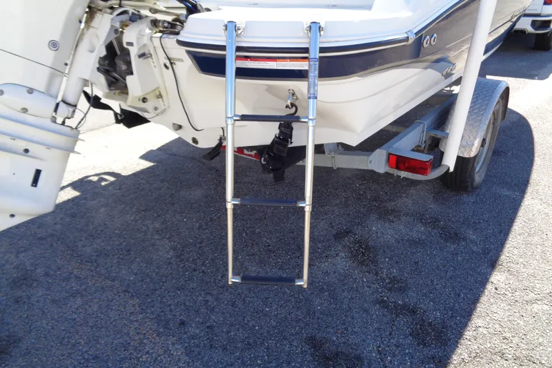 Slide: The Image of 2016 Stingray 192 SC boat with ladder and trailer, rear view. - 8