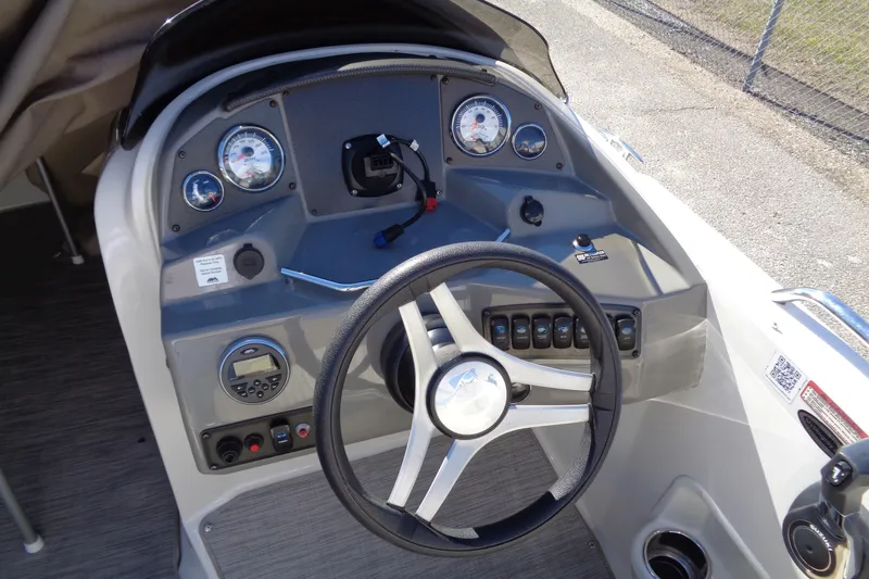 Slide: The Image of 2016 Stingray 192 SC boat dashboard with steering wheel and gauges. - 9