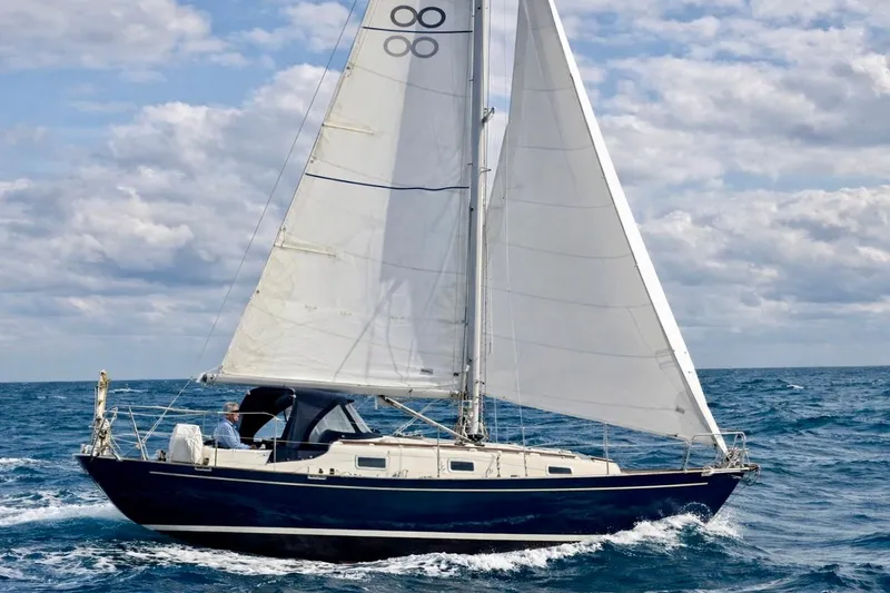 The Image of Sailing yacht Contessa 32 from 1990 navigating ocean waters under cloudy skies. - 0