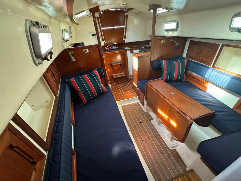 Slide: The Image of Interior of a 1990 Contessa 32 yacht with wooden furnishings. - 13