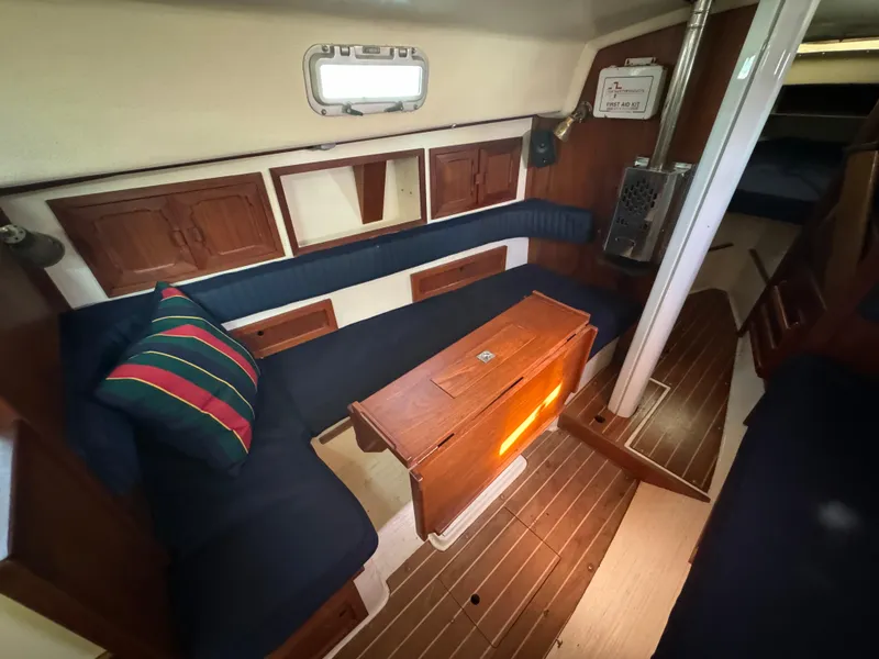 Slide: The Image of Interior of a 1990 Contessa 32 yacht with wooden furnishings. - 14