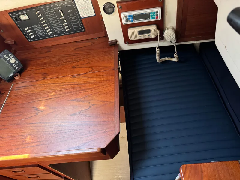 Slide: The Image of Interior of a 1990 Contessa 32 yacht with wooden table and radio. - 20