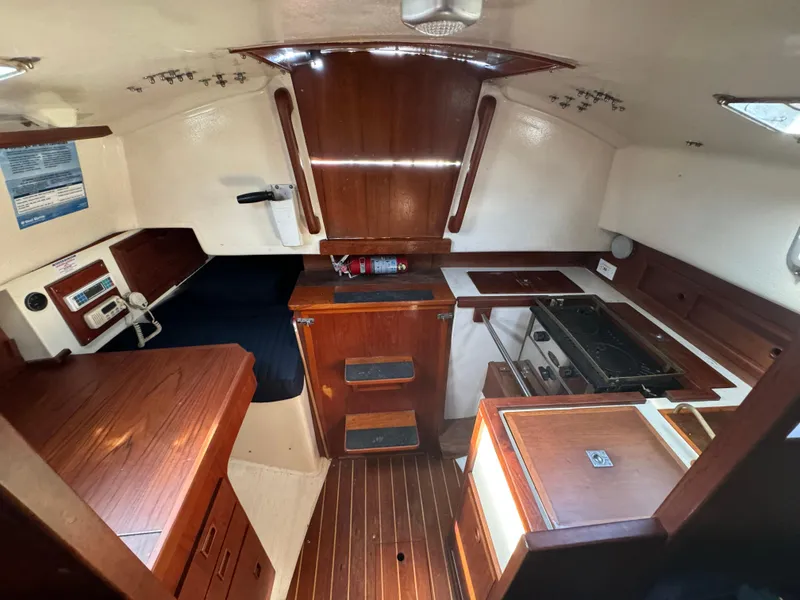 Slide: The Image of Interior of a 1990 Contessa 32 sailboat with wooden furnishings. - 26