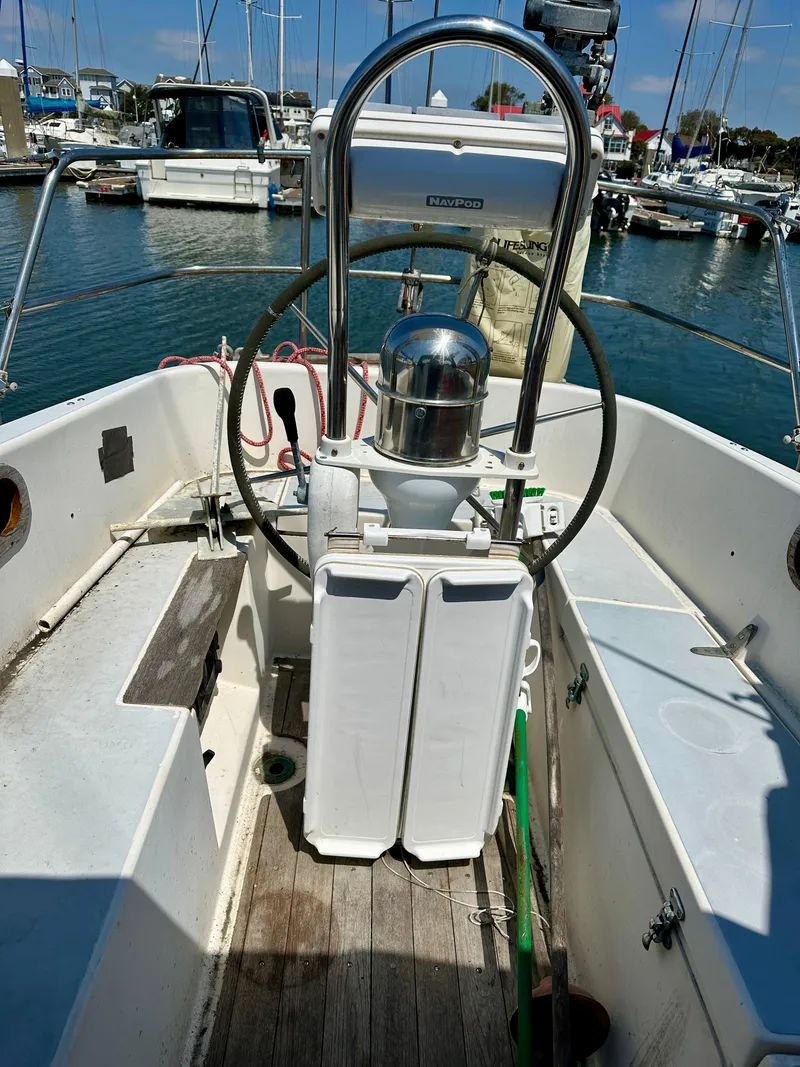 Slide: The Image of Cockpit of a 1990 Contessa 32 sailboat docked in a marina. - 27