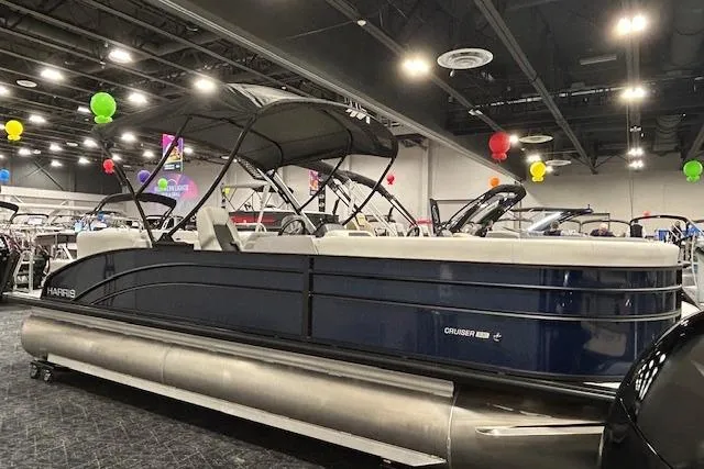The Image of 2026 Harris Cruiser 230 pontoon boat displayed indoors with colorful balloons. - 1