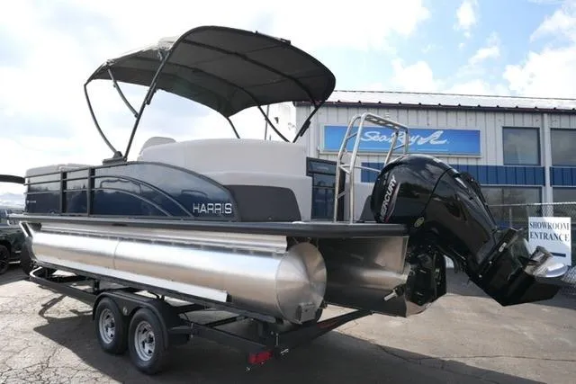 Slide: The Image of 2026 Harris Cruiser 230 pontoon boat on trailer, featuring a Mercury outboard motor. - 12