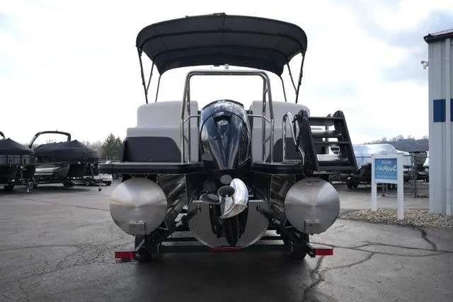 Slide: The Image of 2026 Harris Cruiser 230 pontoon boat with canopy, rear view in a marina setting. - 13