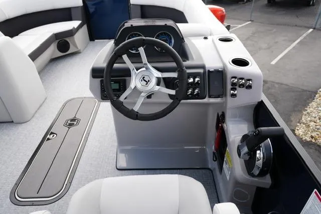 Slide: The Image of 2026 Harris Cruiser 230 boat dashboard with steering wheel and control panel. - 18