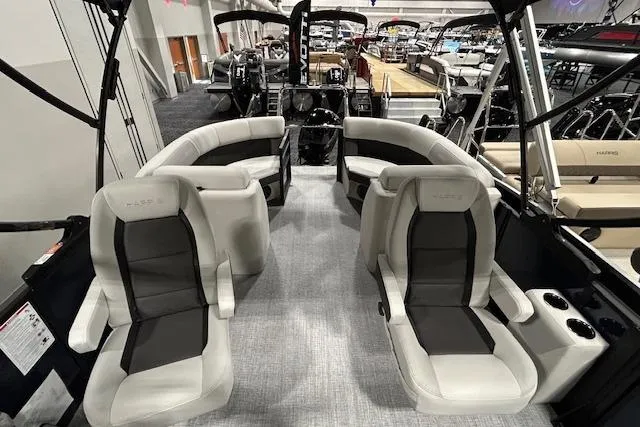 Slide: The Image of 2026 Harris Cruiser 230 boat interior with luxurious seating at a boat show. - 4