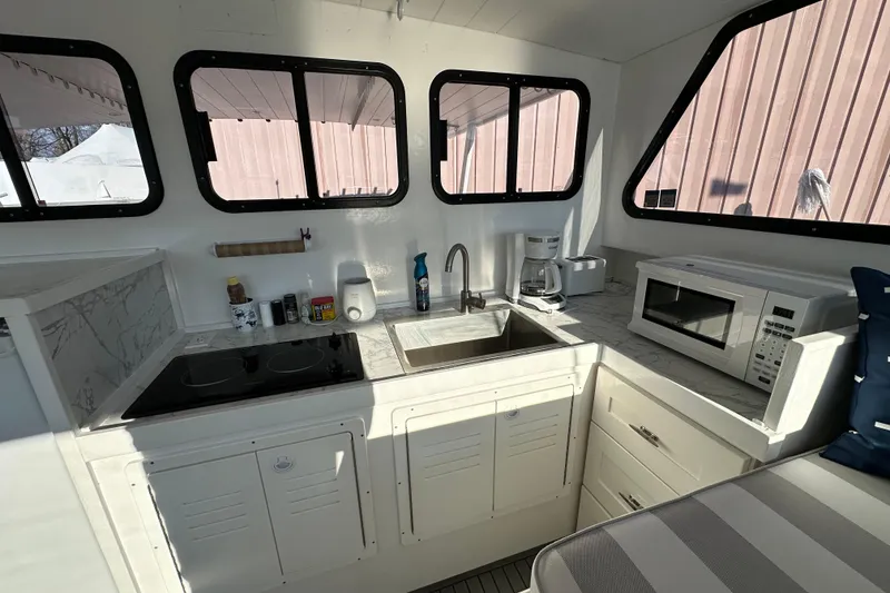Slide: The Image of Compact kitchen inside 2005 Evans 38 Chesapeake Bay Boat with stove, sink, and microwave. - 12