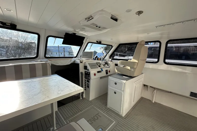 Slide: The Image of Interior of 2005 Evans 38 Chesapeake Bay Boat with helm, seating, and navigation equipment. - 13