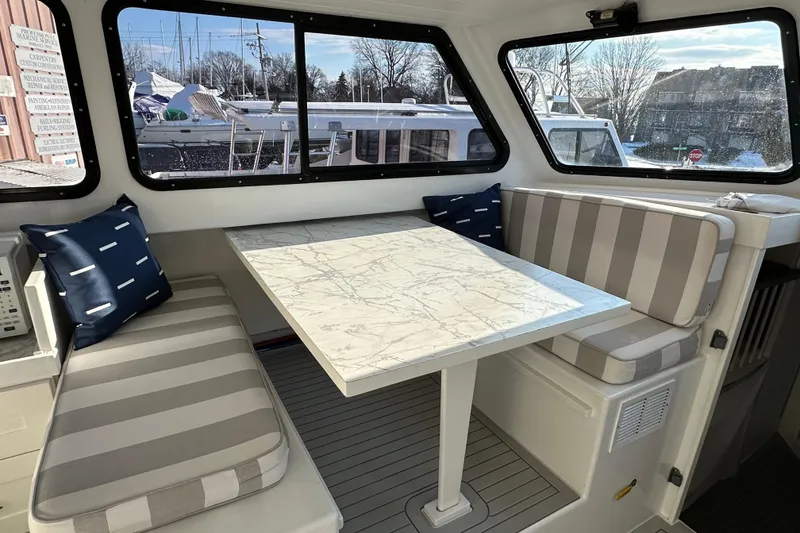Slide: The Image of Interior of 2005 Evans 38 Chesapeake Bay Boat with striped seating and marble table. - 14