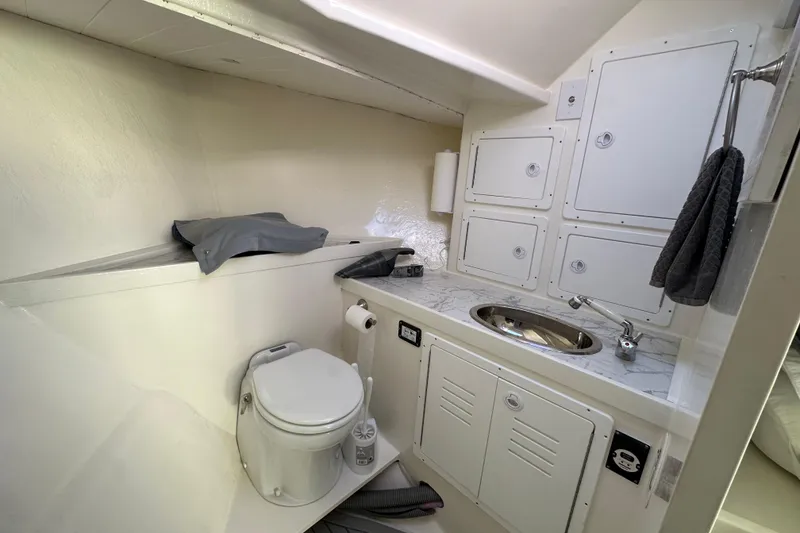 Slide: The Image of Compact bathroom in a 2005 Evans 38 Chesapeake Bay Boat, featuring a toilet and sink. - 15