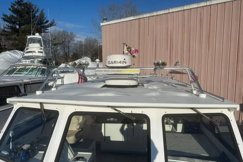 Slide: The Image of 2005 Evans 38 Chesapeake Bay Boat with Garmin radar, docked near other vessels. - 18