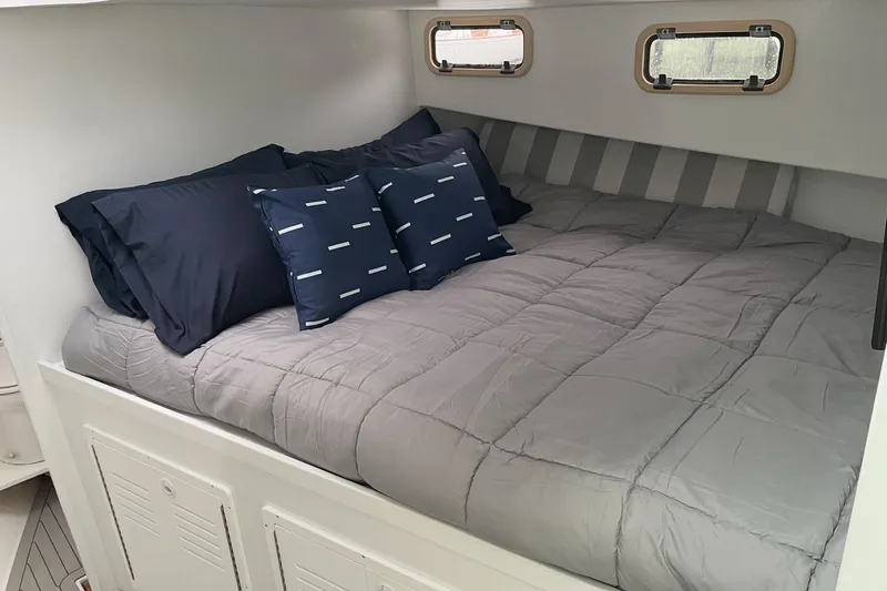Slide: The Image of Cozy cabin bed in 2005 Evans 38 Chesapeake Bay Boat with navy and gray bedding. - 21