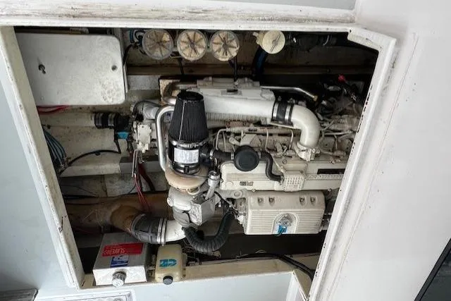 Slide: The Image of Engine compartment of a 2005 Evans 38 Chesapeake Bay Boat, showcasing mechanical components. - 23