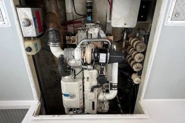 Slide: The Image of Engine compartment of a 2005 Evans 38 Chesapeake Bay Boat, showcasing mechanical components. - 24