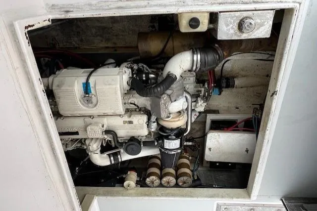 Slide: The Image of Engine compartment of a 2005 Evans 38 Chesapeake Bay Boat, showcasing mechanical components. - 25