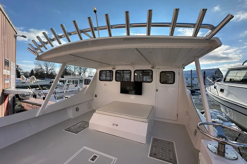 Slide: The Image of 2005 Evans 38 Chesapeake Bay Boat, spacious deck, rod holders, marina setting. - 4