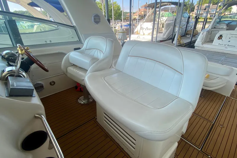 Slide: The Image of 1998 Sea Ray Sundancer 310 interior with white leather seating and wooden flooring. - 10