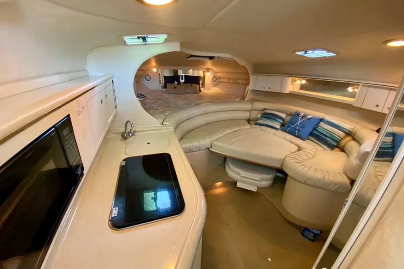 Slide: The Image of 1998 Sea Ray Sundancer 310 cabin interior with kitchenette and seating area. - 13