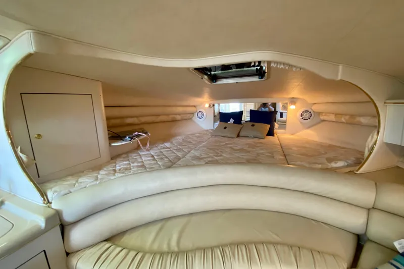 Slide: The Image of Interior cabin of 1998 Sea Ray Sundancer 310 with cozy bedding and ambient lighting. - 15