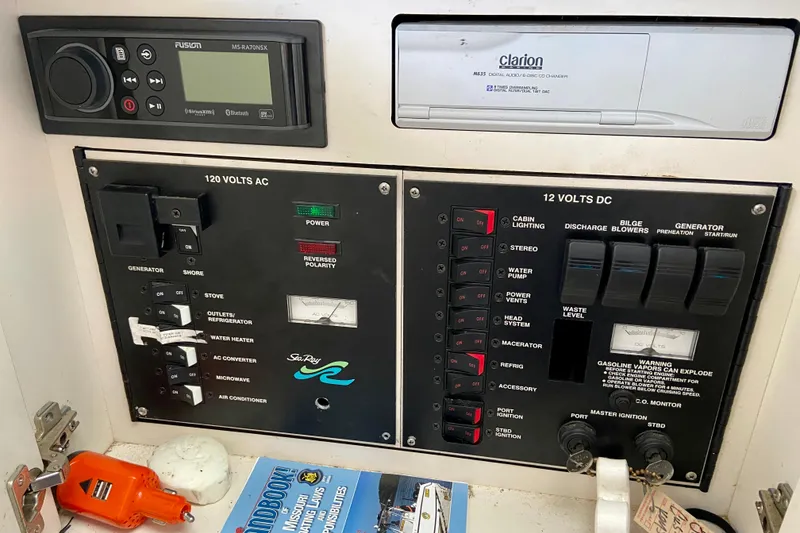 Slide: The Image of Electrical control panel of a 1998 Sea Ray Sundancer 310 boat, featuring AC and DC switches. - 22