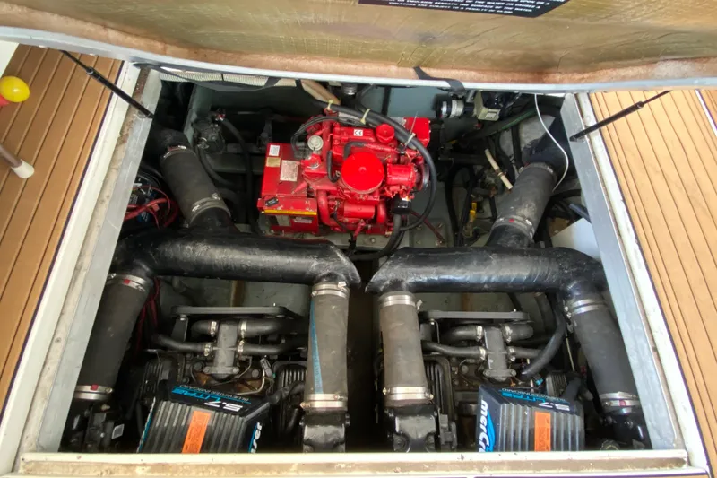 Slide: The Image of Engine compartment of a 1998 Sea Ray Sundancer 310 boat, featuring dual engines and red generator. - 23