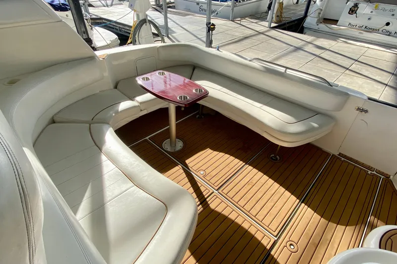Slide: The Image of 1998 Sea Ray Sundancer 310 interior with white seating and wooden flooring. - 26