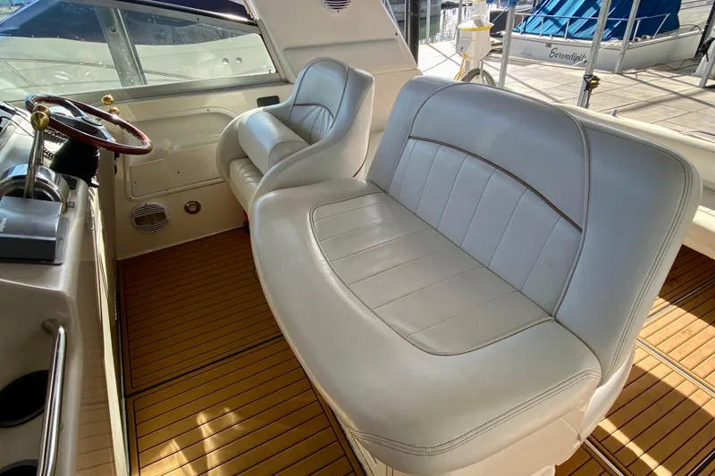 Slide: The Image of 1998 Sea Ray Sundancer 310 interior with white leather seating and wooden flooring. - 27
