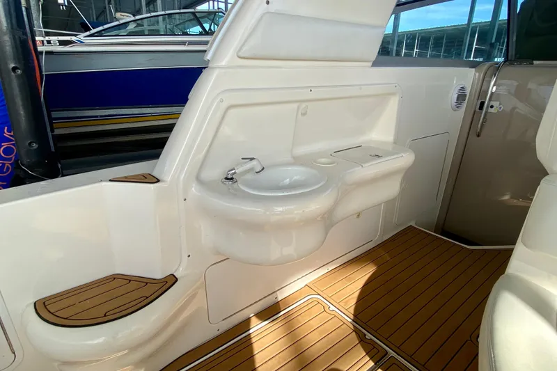 Slide: The Image of 1998 Sea Ray Sundancer 310 interior with sink and wooden flooring. - 28