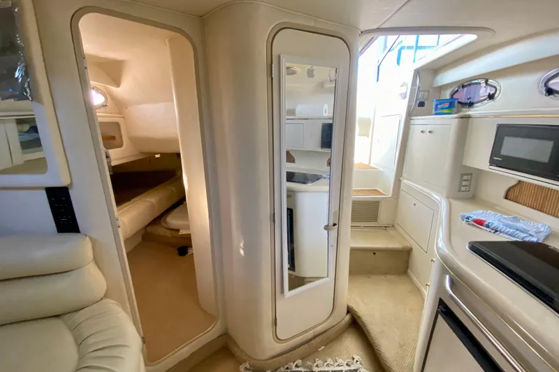 Slide: The Image of Interior of 1998 Sea Ray Sundancer 310 yacht, featuring cozy cabin and kitchenette. - 35