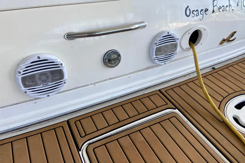 Slide: The Image of 1998 Sea Ray Sundancer 310 boat deck with speakers and power cable. - 6
