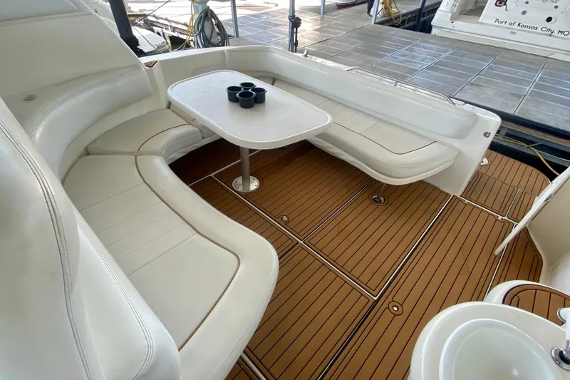Slide: The Image of 1998 Sea Ray Sundancer 310 boat interior with white seating and wooden deck. - 7
