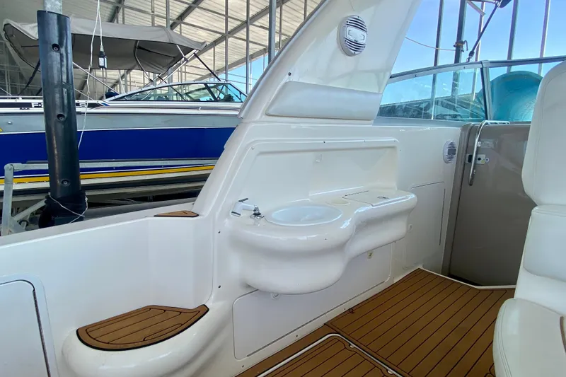 Slide: The Image of Interior of 1998 Sea Ray Sundancer 310 boat with sink and seating area. - 9