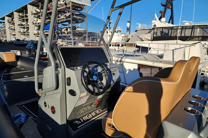 Slide: The Image of 2026 Highfield Escape 650 boat interior with steering wheel and tan seating. - 10