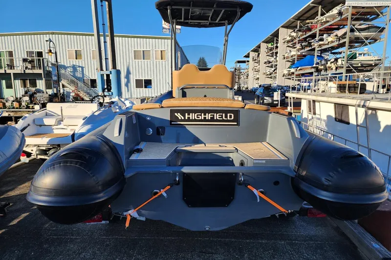 Slide: The Image of 2026 Highfield Escape 650 boat docked at marina, rear view. - 9