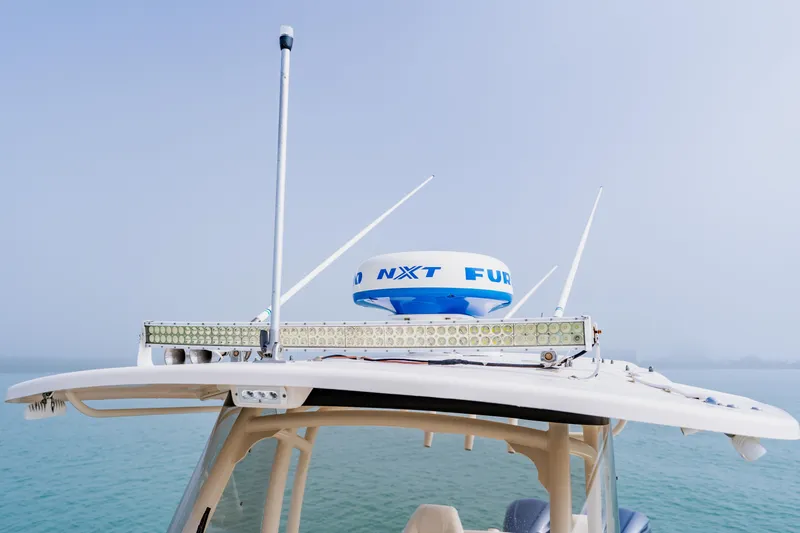 Slide: The Image of 2021 Grady-White Canyon 306 boat with radar and antennas on the roof. - 18