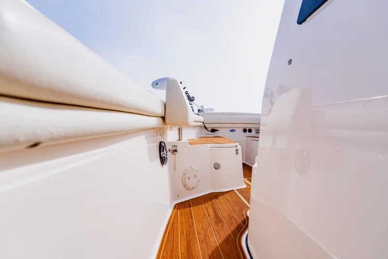 Slide: The Image of 2021 Grady-White Canyon 306 boat interior with sleek design and wooden flooring. - 19