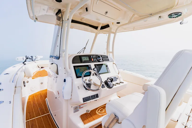 Slide: The Image of 2021 Grady-White Canyon 306 boat interior with modern helm and ocean view. - 21
