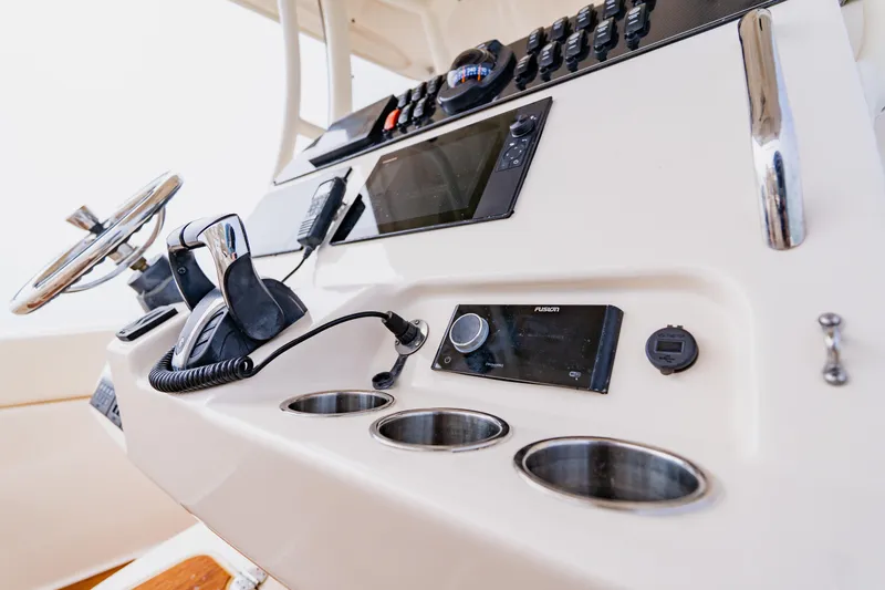 Slide: The Image of Control panel of 2021 Grady-White Canyon 306 boat with steering wheel and electronics. - 23