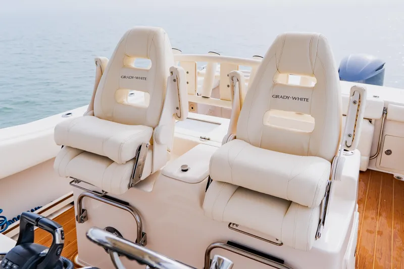 Slide: The Image of 2021 Grady-White Canyon 306 boat seats, luxurious design, ocean backdrop. - 29