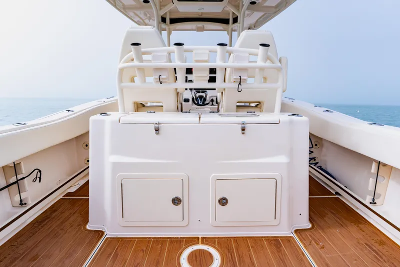 Slide: The Image of 2021 Grady-White Canyon 306 boat interior with teak flooring and fishing rod holders. - 33