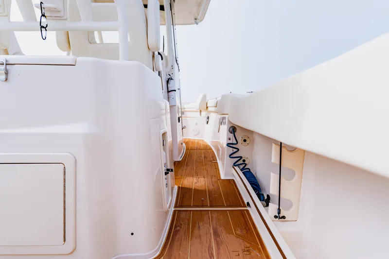 Slide: The Image of 2021 Grady-White Canyon 306 boat deck with sleek design and wooden flooring. - 36