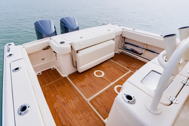Slide: The Image of 2021 Grady-White Canyon 306 boat deck with twin engines and teak flooring. - 37