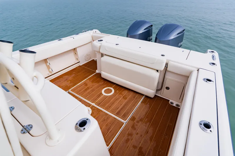 Slide: The Image of 2021 Grady-White Canyon 306 boat deck with seating and twin engines on water. - 38