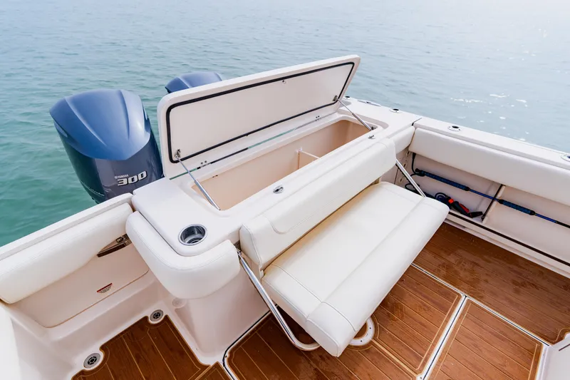Slide: The Image of 2021 Grady-White Canyon 306 boat with open storage and Yamaha 300 engines on water. - 39