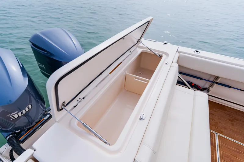 Slide: The Image of 2021 Grady-White Canyon 306 boat with open storage compartment and twin Yamaha 300 engines. - 40