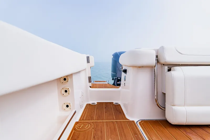 Slide: The Image of 2021 Grady-White Canyon 306 boat interior with teak flooring and white seating. - 43
